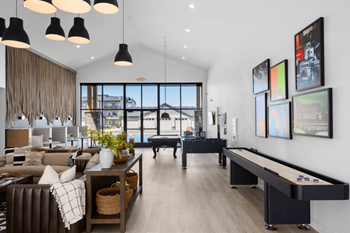 A living room with a foosball table and a large window